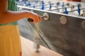 Hand playing foosball. People enjoying table soccer game Royalty Free Stock Photo