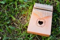 Hand playing kalimba or mbira is an African musical instrument.made from wooden board with metalInstrument in garden