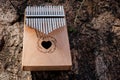 Hand playing kalimba or mbira is an African musical instrument.made from wooden board with metalInstrument in garden