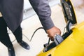 Hand Plugging In Electric Car Outside Office In Car Park Charging