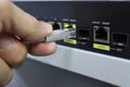 Hand plugging an Ethernet cable into a network switch port Royalty Free Stock Photo