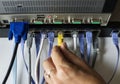 Hand is plugging a LAN cable to the hub Royalty Free Stock Photo