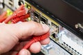 Hand Plugging Network Cable Into Switch In Datacenter Royalty Free Stock Photo