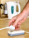 Plugging in a power cord to a Dangerous Broken SocketPower Cords in a Dangerouse Tangled Mess Royalty Free Stock Photo