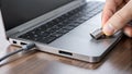 Hand plugging USBC adapter into laptop port computer. Royalty Free Stock Photo