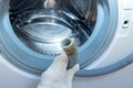 Hand of a plumber holding a broken flexible drain hose of washing machine, clogged and covered with lime scale, dirt limescale and Royalty Free Stock Photo