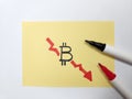 Hand pointing at aDownward graph depicting bitcoin plunge Royalty Free Stock Photo