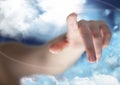 Hand pointing against cloudy sky in background Royalty Free Stock Photo