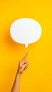 Hand pointing blank speech bubble on yellow background Royalty Free Stock Photo