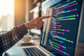 Hand Pointing at Colorful Lines of Code on Computer Screen and a shallow depth of field - generated by ai Royalty Free Stock Photo