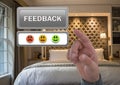 Hand pointing at feedback button and smiley faces review in accommodation bedroom Royalty Free Stock Photo