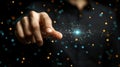 Hand pointing glowing orb, dark background, bokeh lights, digital interaction Royalty Free Stock Photo