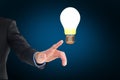 A hand pointing light bulb Royalty Free Stock Photo