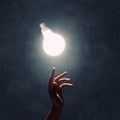 Hand pointing light bulb Royalty Free Stock Photo