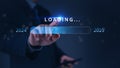 A hand pointing at a loading bar with a transition from 2024 to 2025 strategic planning, symbolizing progress and the future Royalty Free Stock Photo