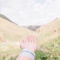 Hand pointing at mountain valley. Royalty Free Stock Photo