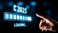 Hand pointing at a screen that says loading and 2025 Royalty Free Stock Photo