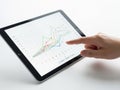 Hand pointing at tablet screen with graphs and charts, isolated on white background Royalty Free Stock Photo