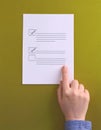 A hand pointing to a checklist with two checked boxes and one unchecked box on a green background Generative AI