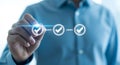 Hand pointing to digital checkmarks in a workflow sequence checklist approval Royalty Free Stock Photo