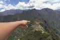 hand pointing to machu picchu, Huaynapicchu Mountain, Machu Picchu, Peru - Ruins of Inca Empire city Royalty Free Stock Photo