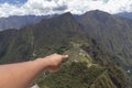 hand pointing to machu picchu, Huaynapicchu Mountain, Machu Picchu, Peru - Ruins of Inca Empire city Royalty Free Stock Photo