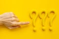 Hand points to question mark sign. Solving problem or search solution concept Royalty Free Stock Photo
