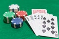 Hand of poker, Royal flush of spades, chips on green background Royalty Free Stock Photo