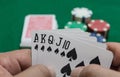 Hand of poker, Royal flush of spades, chips on green background Royalty Free Stock Photo