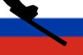 hand with police tonfa rubber stick silhouette and blurry russian flag in the background