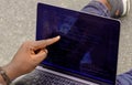 Hand portrait of african web developer pointing finger at line of computer code