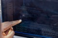 Hand portrait of african web developer pointing finger at line of computer code