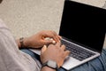 Hand portrait of an African web developer working with his laptop, with a smartwatch Royalty Free Stock Photo
