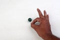 Finger pointing a marble ball Royalty Free Stock Photo