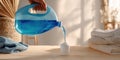 The hand pouring blue detergent into a container for laundry preparation. AI generated image Royalty Free Stock Photo