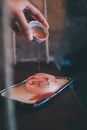 Hand pouring brown sugar sauce over Sakura Mizu Shingen Mochi japanese dessert.A Japanese style dessert with decoration. Royalty Free Stock Photo