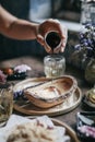 Hand pouring Brown Sugar Syrup into Mizu Shingen Mochi japanese dessert.A Japanese style dessert with decoration. Royalty Free Stock Photo