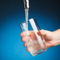 Hand pouring a glass of drinking water