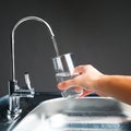 Hand pouring a glass of water