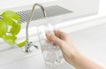 Hand pouring a glass of water from kitchen filter tap Royalty Free Stock Photo