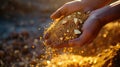 Hand pouring golden sand with gold nuggets at sunset