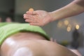 Hand pouring oil for massage in spa studio. Oil drop Royalty Free Stock Photo