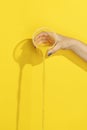 Hand pouring orange juice in disposable cup