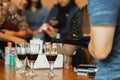 Hand pouring red wine in glass during party with friends. Royalty Free Stock Photo