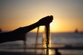 Hand pouring sand from a beach Royalty Free Stock Photo