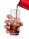 Hand pouring soft drink soda on iced glass