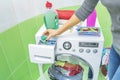 Hand pours liquid powder into the washing machine. Royalty Free Stock Photo