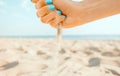 Hand pours sand on coastline. Royalty Free Stock Photo