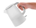 Hand pours water from an electric kettle on a white isolated background Royalty Free Stock Photo