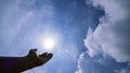 Hand praying for blessing from god on sun and clouds background,Christian Religion concept Royalty Free Stock Photo